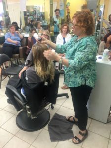 Kelly E. Anker performing the application of Olaplex for wavy hair. 