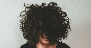 A woman enjoying her naturally textured hair.