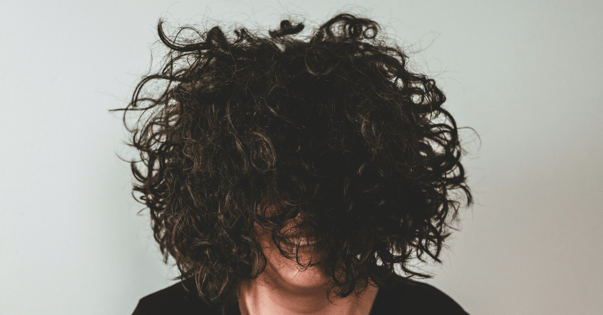 A woman enjoying her naturally textured hair.
